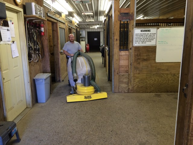 Bruce vacuuming the aisle in the main barn